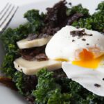 Poached Eggs Nestled on Sautéed Kale and Mushrooms Delight